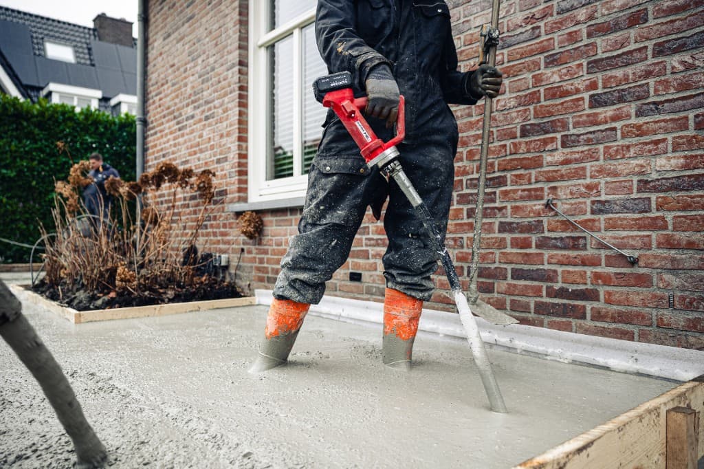 Lievers poker vibrator compacting fresh concrete on a construction site